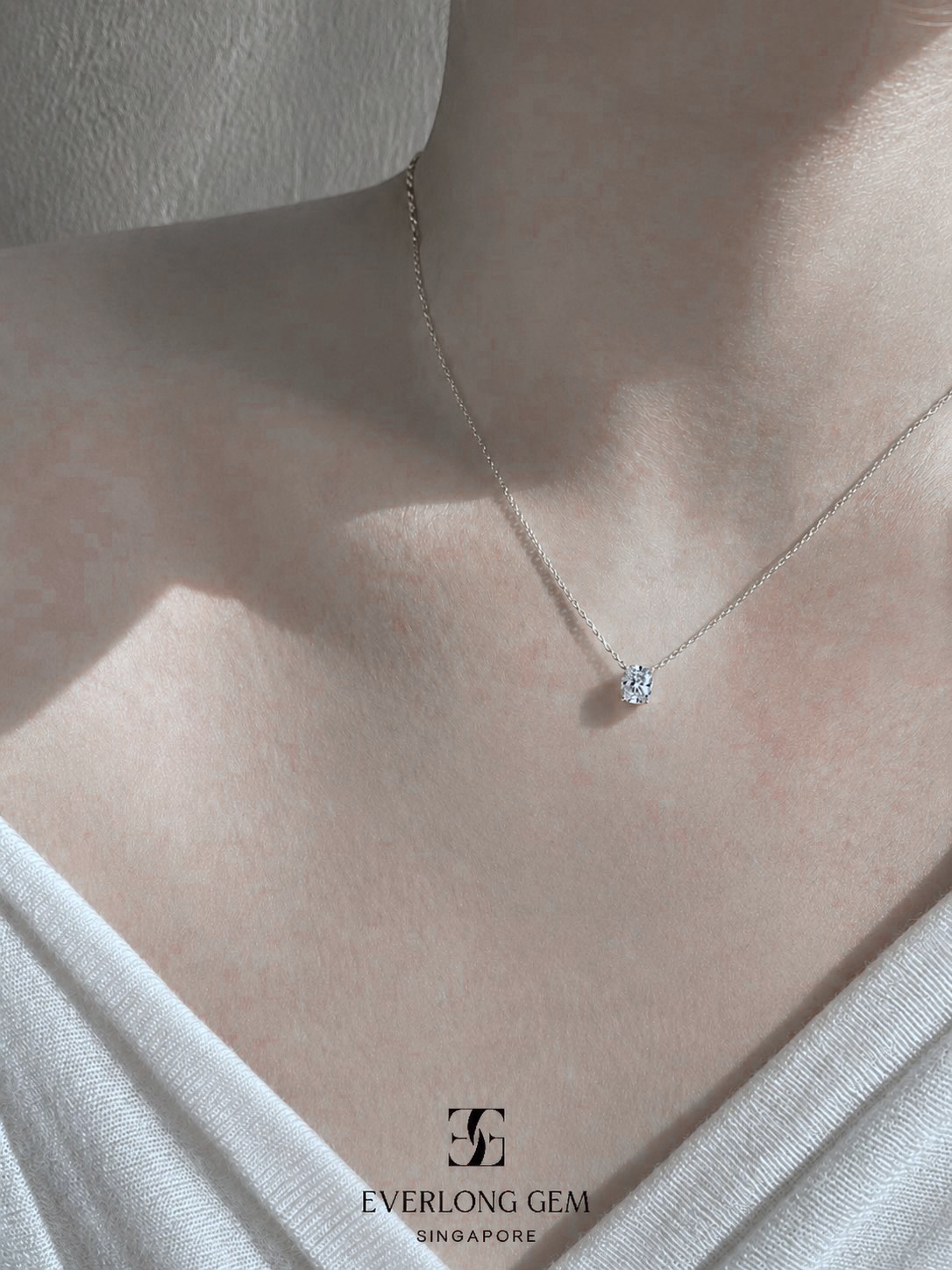 A fine chain with a small Everlong Gem diamond worn at the collarbone