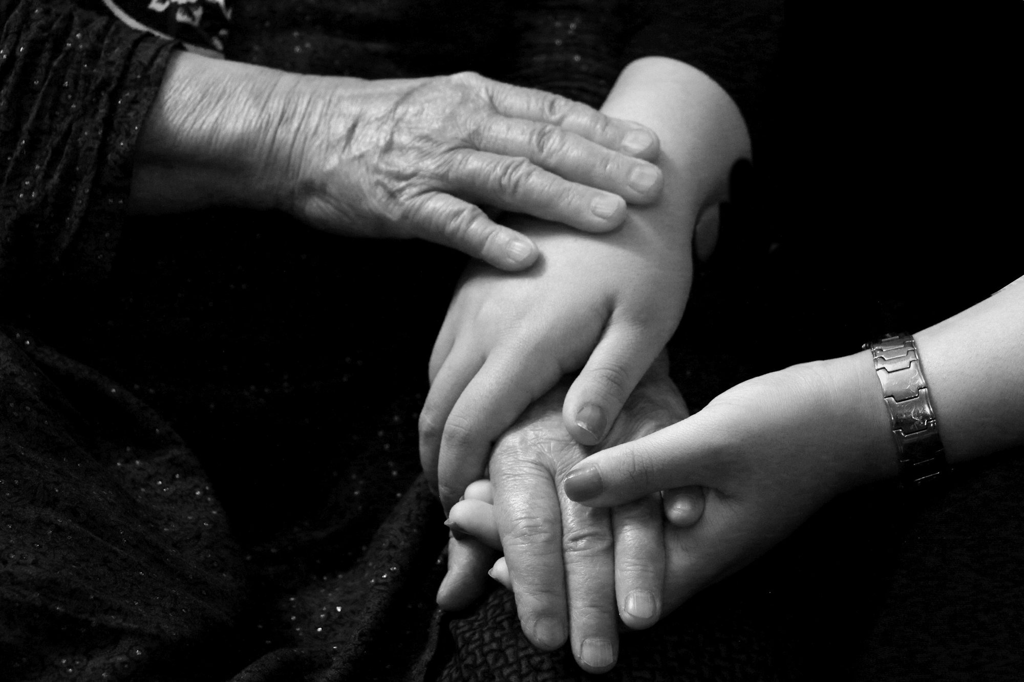 Three generations of hands held together